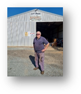 A person standing in front of a building

Description automatically generated
