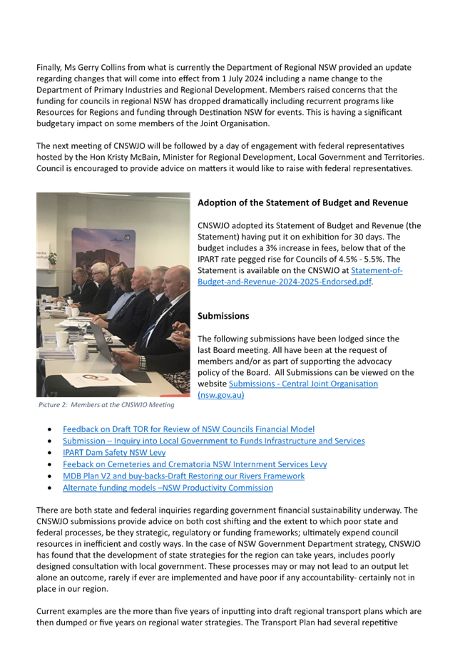 A group of men sitting at a table

Description automatically generated