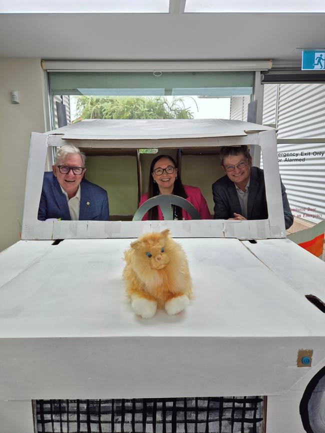 A group of people sitting in a white box with a cat in the back

AI-generated content may be incorrect.